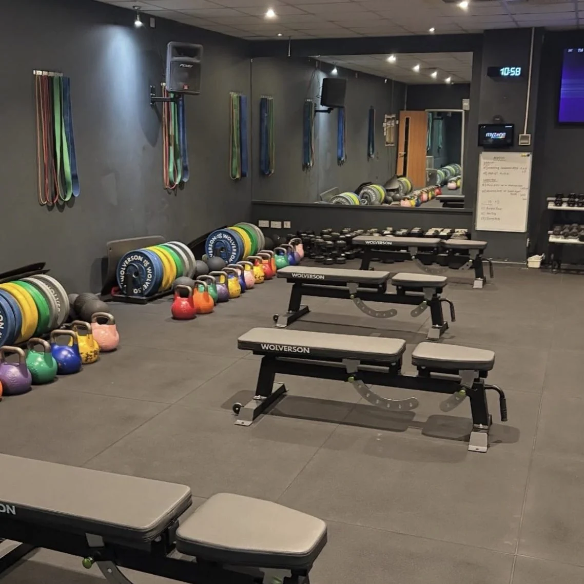 Training space with weights, benches and exercise equipment, from Adjuvo’s current website.